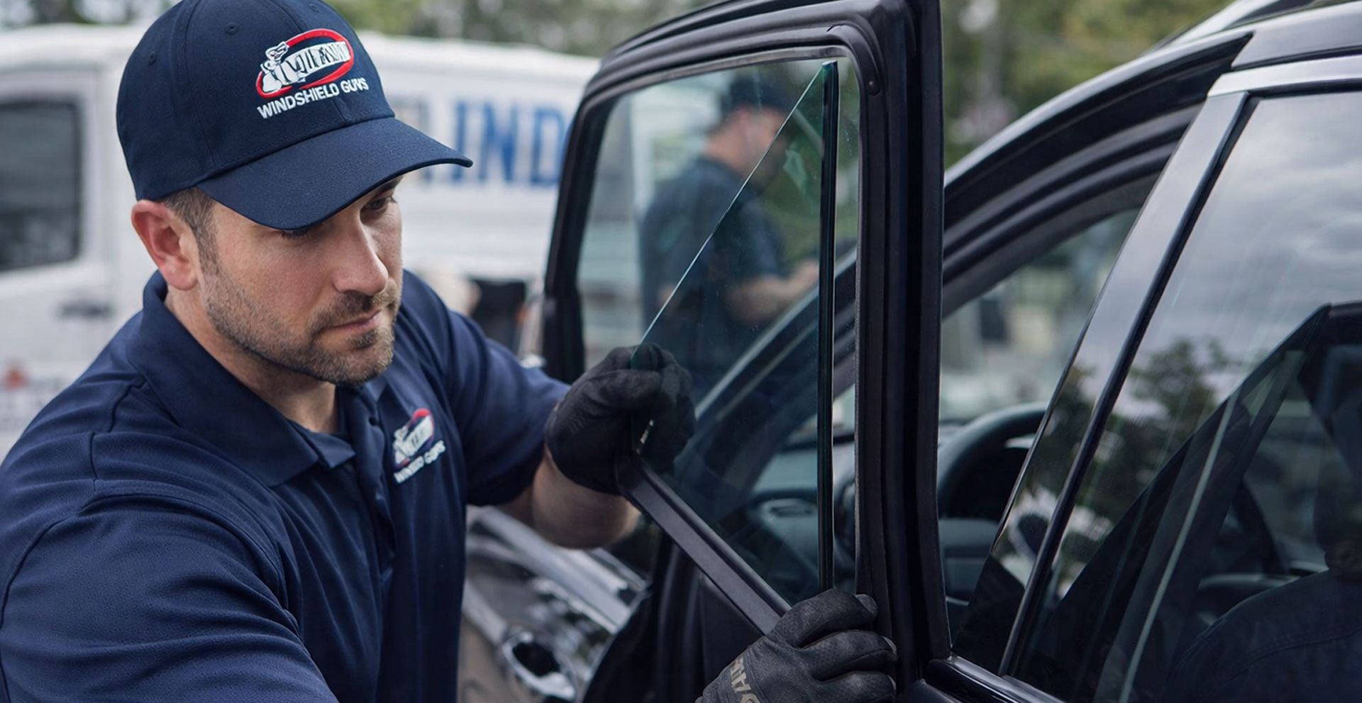 Auto glass technician working on a vehicle
